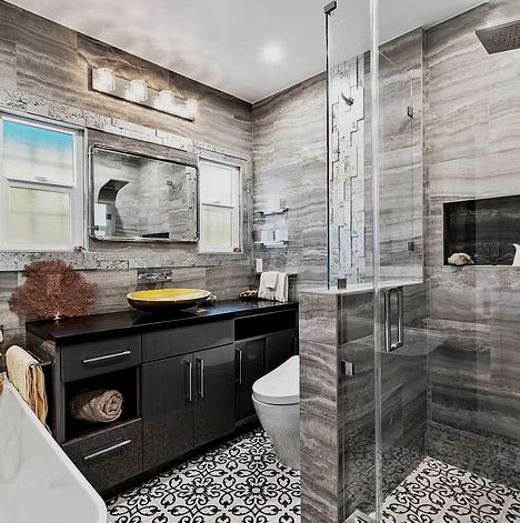 Modern bathroom remodel with custom tile, glass shower, and dark vanity by Green Property Doctors